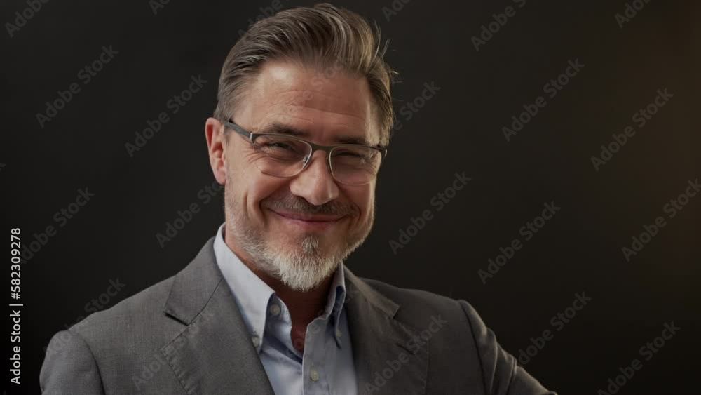 Business portrait - businessman smiling, showing thumbs up. Portrait of mature age, middle age, mid adult man in 50s, happy confident smile. Copy space. Business portrait - businessman smiling, showing thumbs up. Portrait of mature age, middle age, mid adult man in 50s, happy confident smile. Copy space.