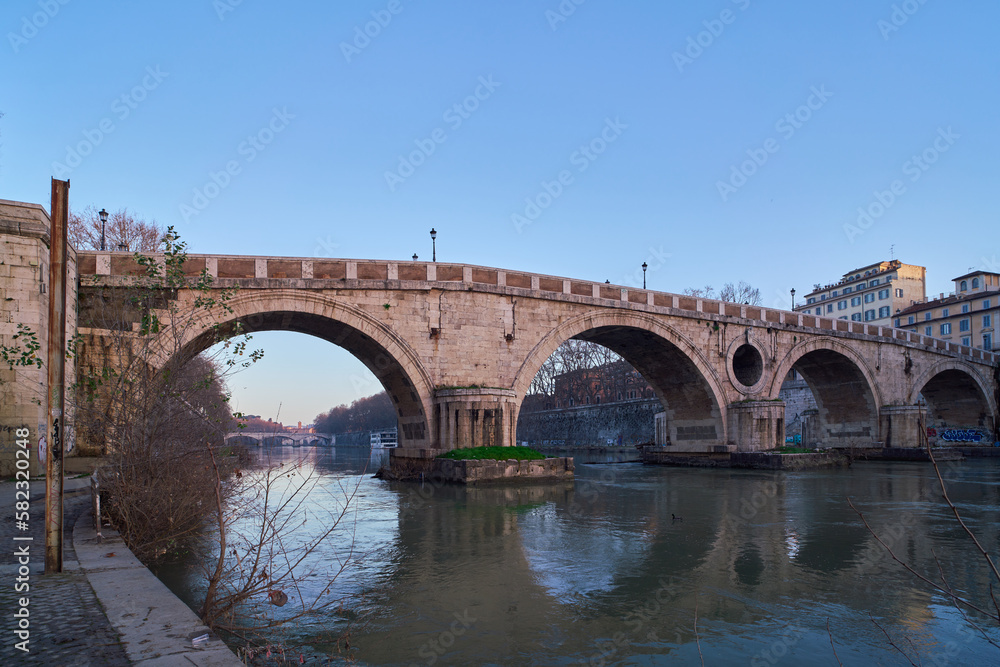 Early morning view of Ponte Sisto from below, a bridge of river Tiber in Rome, Italy