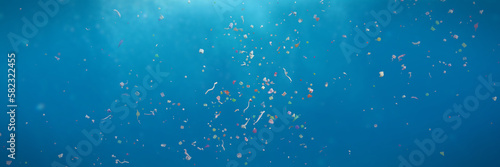 Obraz na płótnie plastic pollution in the ocean, microplastics in the current, background banner format (3d illustration) w salonie