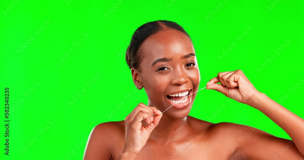 Face, dental floss and woman against green screen for teeth, cleaning and hygiene on studio background space. Oral, portrait and happy girl flossing for fresh, clean and breath, routine or prevention