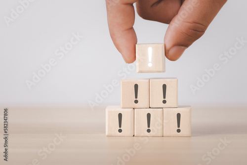 Wooden blocks showing white exclamation marks, warnings, errors, alerts, maintenance and finding solutions. white background