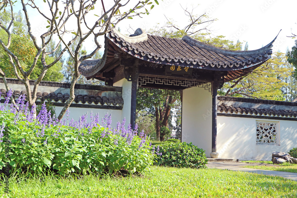 Classic Chinese Garden Surrounded by a White Wall with Traditional Gate Classic Chinese Garden Surrounded by a White Wall with Traditional Gate
