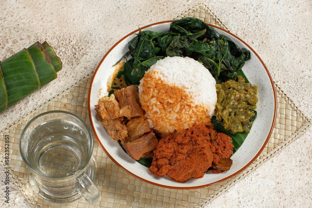 Nasi Padang with rendang is an Indonesian food from West Sumatra in Indonesia. Nasi Padang as favorites food for Indonesian people. Nasi Padang with rendang is an Indonesian food from West Sumatra in Indonesia. Nasi Padang as favorites food for Indonesian people.