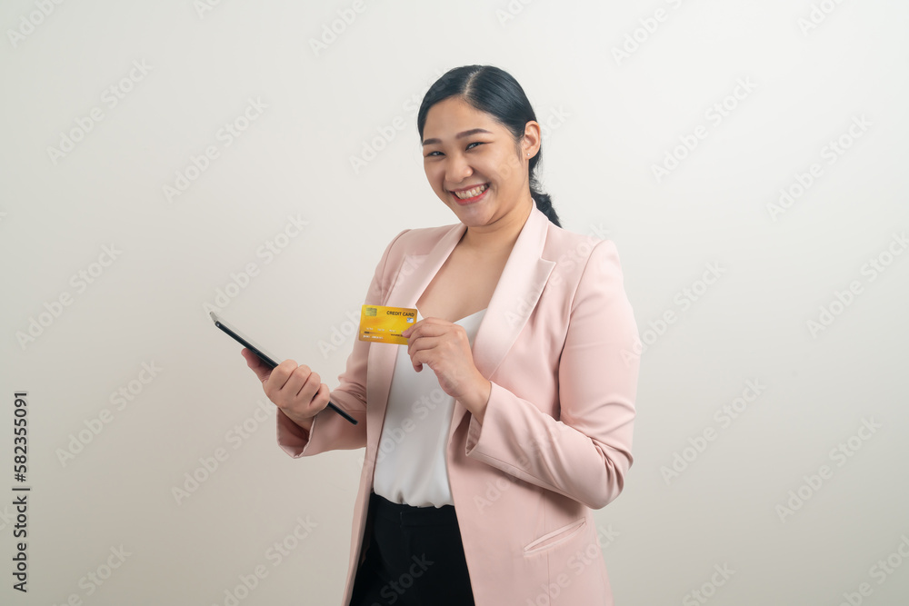 Asian woman using smartphone with hand holding credit card Asian woman using smartphone with hand holding credit card