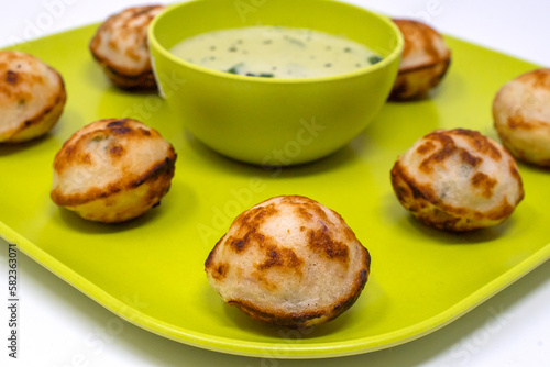 Closeup shot of kuzhi paniyaram, guliyappa, paddu with coconut chutneya