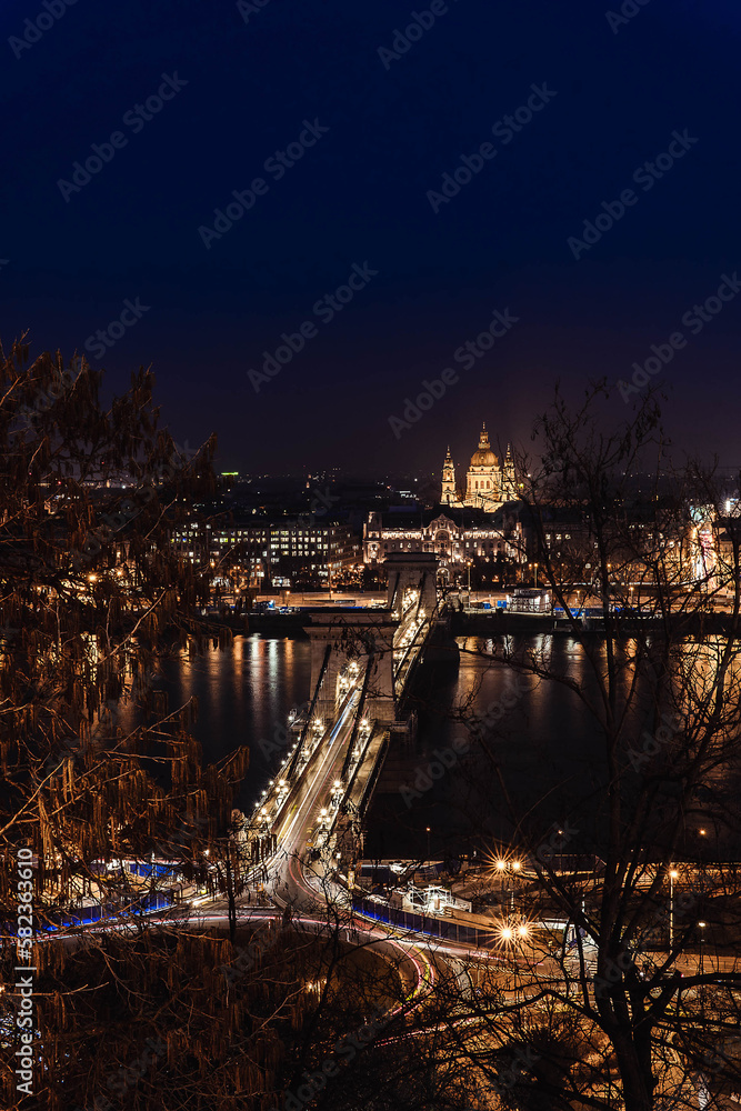 stock photo of high view of chain bridge against domes at night