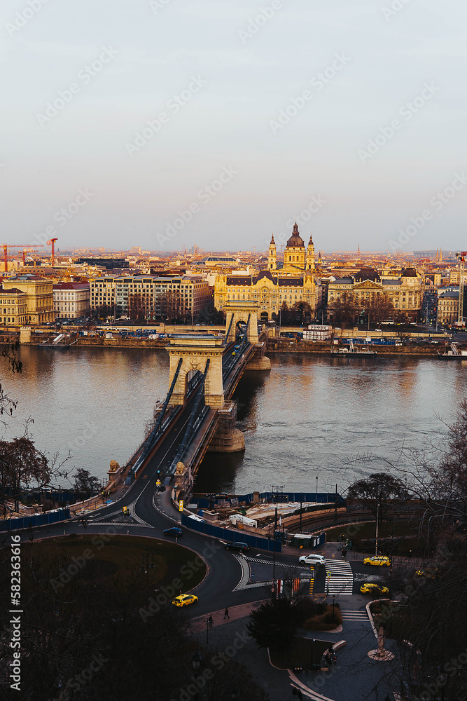 stock photo of high view of chain bridge against domes at sunset