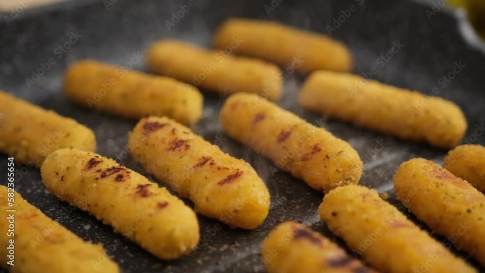 Mozzarella Cheese sticks are fried in oiled grill frying pan Mozzarella Cheese sticks are fried in oiled grill frying pan