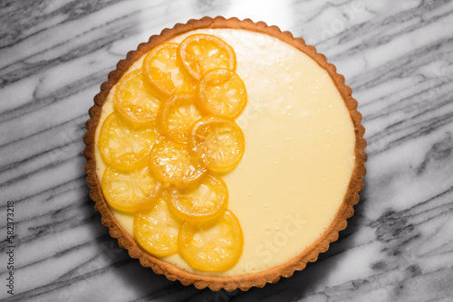 Overhead view of lemon tart on marble counter photo