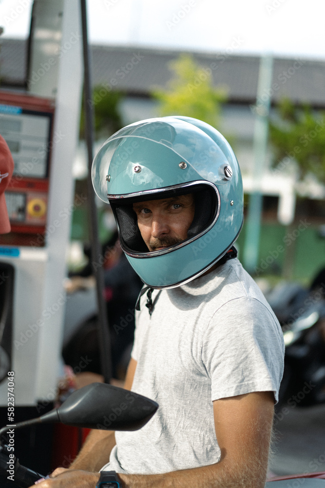 A man in a motorcycle helmet. Bali, Indonesia A man in a motorcycle helmet. Bali, Indonesia
