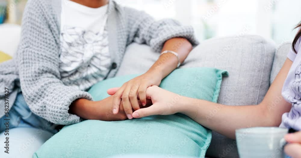 Holding hands, support and woman in a home living room with hope, trust and solidarity. House, people and love with forgiveness and grief of friends with empathy, kindness and gratitude together Holding hands, support and woman in a home living room with hope, trust and solidarity. House, people and love with forgiveness and grief of friends with empathy, kindness and gratitude together