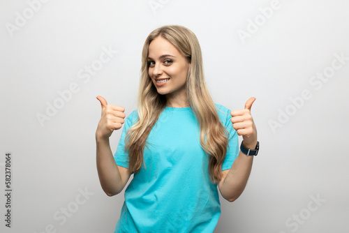 a girl in a blue t-shirt shows class on a white background
