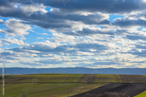 colorful different fields with wonderful clouds at the blue sky
