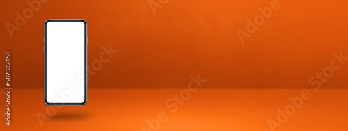 Floating smartphone isolated on orange. Horizontal banner background