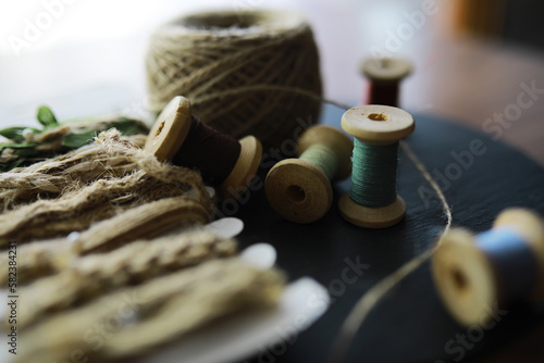 Old scissors, spools of colored thread, centimeter and tailors chalk, flat lay, concept of sewing clothes