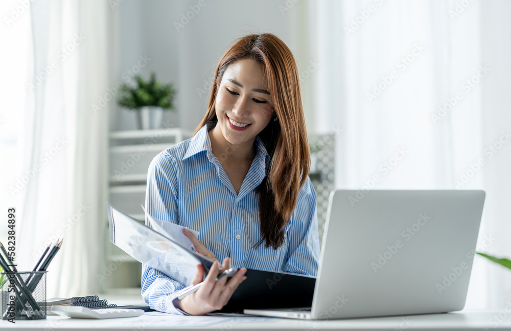Senior executive or businesswoman looking at and examining company financial files in the real estate project division. Senior executive or businesswoman looking at and examining company financial files in the real estate project division.