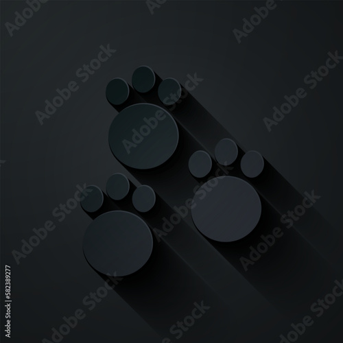 Paper cut Paw print icon isolated on black background. Dog or cat paw print. Animal track. Paper art style. Vector