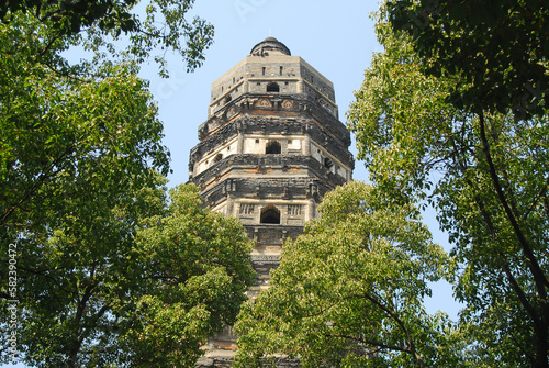 Old historic Tiger Hill pagoda over 1000 years old with natural green trees in Suzhou - China