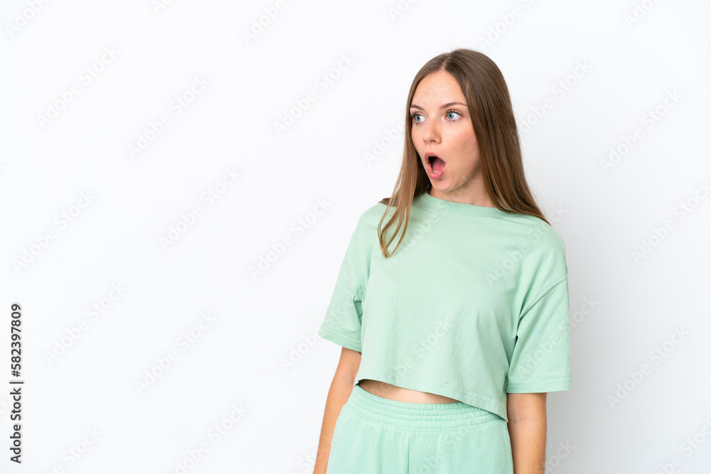 Young Lithuanian woman isolated on white background doing surprise gesture while looking to the side Young Lithuanian woman isolated on white background doing surprise gesture while looking to the side