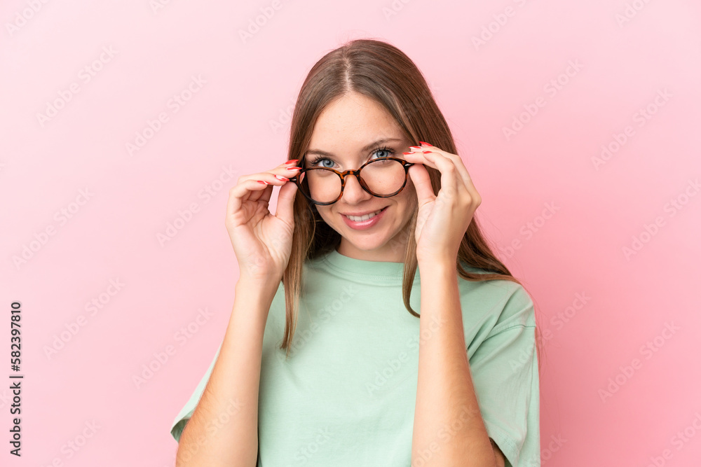 Young Lithuanian woman isolated on pink background With glasses with happy expression Young Lithuanian woman isolated on pink background With glasses with happy expression