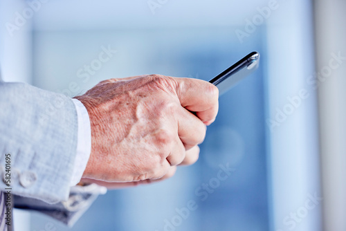 Hands  phone and email with a business man in his office  closeup for communication or networking. Mobile  contact and internet with a male employee typing a text message or making a call