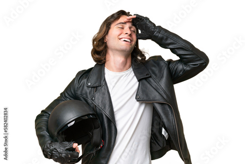 Young handsome man with a motorcycle helmet isolated on green chroma background smiling a lot