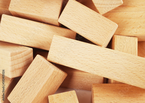 Wooden blocks toy made of natural wood stacked heap pile macro detail close up. Childhood toys concept