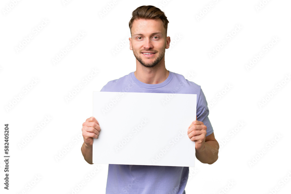 Young blonde caucasian man over isolated background holding an empty placard with happy expression Young blonde caucasian man over isolated background holding an empty placard with happy expression