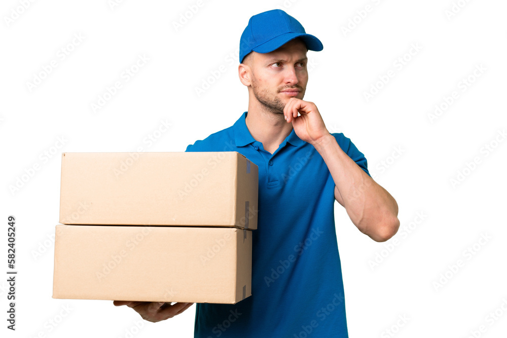 Delivery caucasian man over isolated background and looking up Delivery caucasian man over isolated background and looking up