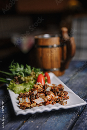 appetizer of small fried ribs on a white plate