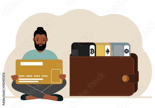 A man holds a card, next to a wallet with different cards for cryptocurrencies. Internet wallet, digital money transactions, exchange platform, cold wallet or hardware wallet.
