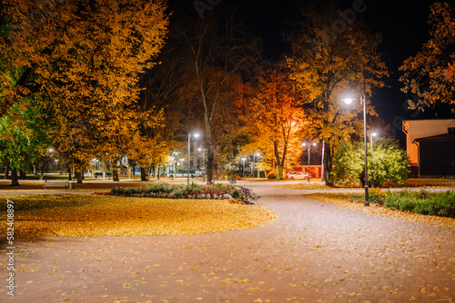 A Night in the Park. Late Autumn Night in the Park. Wood Benches and Park Alley. Horizontal Photography. Central Europe 