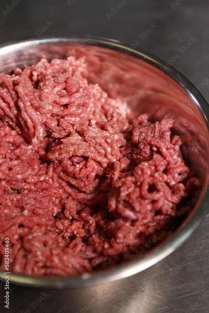 Minced ground beef meat in a stewpan. Natural red cow fillet prepared for cooking in a commercial kitchen Minced ground beef meat in a stewpan. Natural red cow fillet prepared for cooking in a commercial kitchen