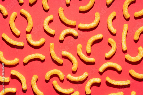 Cheese puffs on red background