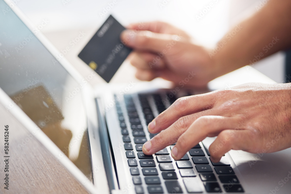 Hands, laptop and credit card for ecommerce, online shopping or electronic purchase on wooden desk. Hand of shopper working on computer keyboard for internet banking, app or wireless transaction Hands, laptop and credit card for ecommerce, online shopping or electronic purchase on wooden desk. Hand of shopper working on computer keyboard for internet banking, app or wireless transaction
