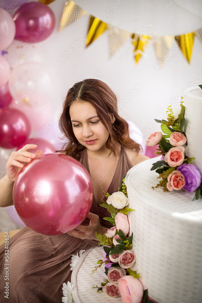 Young teen girl on her birthday with a big cake and balloons Stock ...