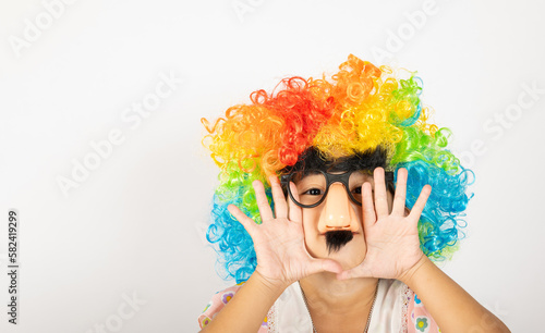 April Fool's Day. Two brothers funny kid little girl clown wears curly wig colorful big nos and glasses and mustache playing fool isolated on white background copy space, Happy child festive decor