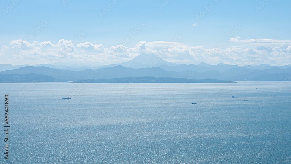 Avacha Bay of the Pacific Ocean mountains and blue skies. Kamchatka Peninsula.