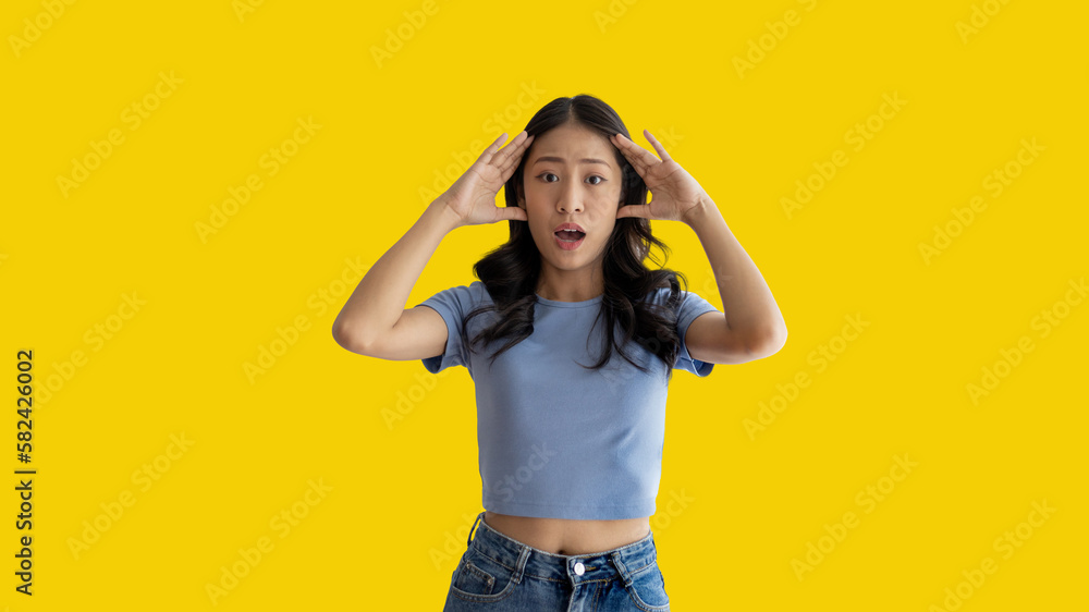Asian woman acting shocked or surprised isolated on a Yellow background, Looking camera, Concept acts according to the emotions and feelings of excitement and shock, Yellow background, Copy space. Asian woman acting shocked or surprised isolated on a Yellow background, Looking camera, Concept acts according to the emotions and feelings of excitement and shock, Yellow background, Copy space.