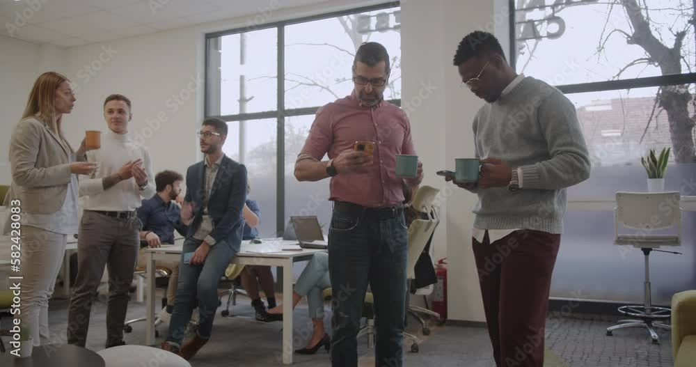 Busy office with many diverse people, working together in teams, trucking movement Busy office with many diverse people, working together in teams, trucking movement