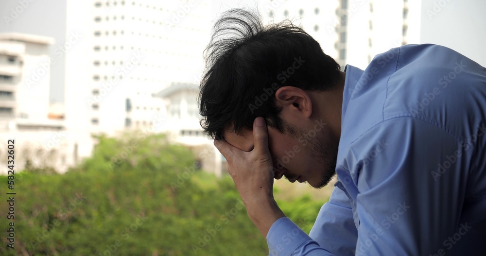 Depressed Asian businessman stressed from work. anxiety in adult cause to depression and a problem in living that drag you down to feeling sadness, lonely and worried Depressed Asian businessman stressed from work. anxiety in adult cause to depression and a problem in living that drag you down to feeling sadness, lonely and worried