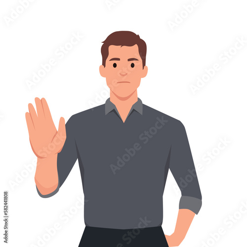 Trendy young business man making or showing stop gesture sign with hand, saying no. Shocked person warning signal with palm of the hand. Human emotions and modern lifestyle