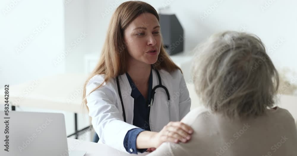 Happy optimistic doctor woman giving psychological support to old senior female patient, touching shoulder, talking, speaking. Elderly lady visiting geriatric practitioner for healthcare checkup Happy optimistic doctor woman giving psychological support to old senior female patient, touching shoulder, talking, speaking. Elderly lady visiting geriatric practitioner for healthcare checkup
