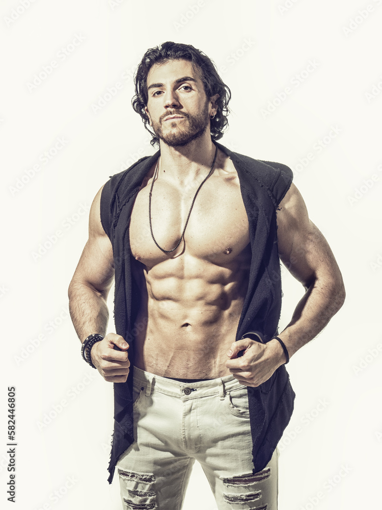 Fototapeta premium Confident, attractive young man with open vest on