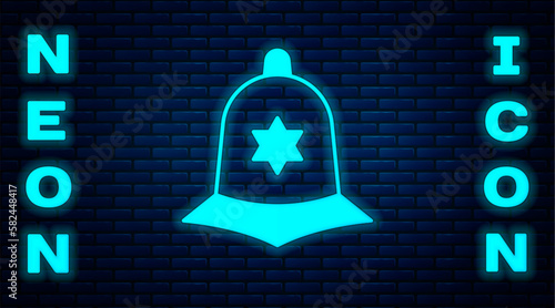 Glowing neon British police helmet icon isolated on brick wall background. Vector
