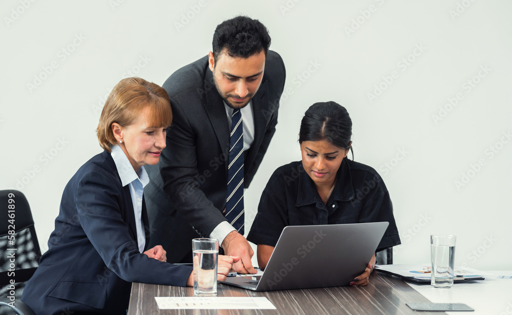 Team of business people meeting and looking at laptop to review financial data Team of business people meeting and looking at laptop to review financial data