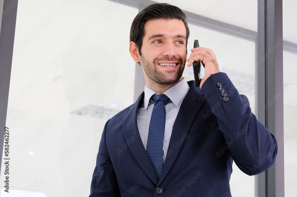 young businessman using phone to communicate with customers. young businessman using phone to communicate with customers.