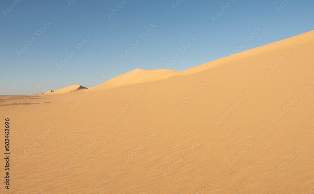 Barren desert landscape in hot climate with sand dunes Barren desert landscape in hot climate with sand dunes
