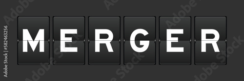 Black color analog flip board with word merger on gray background