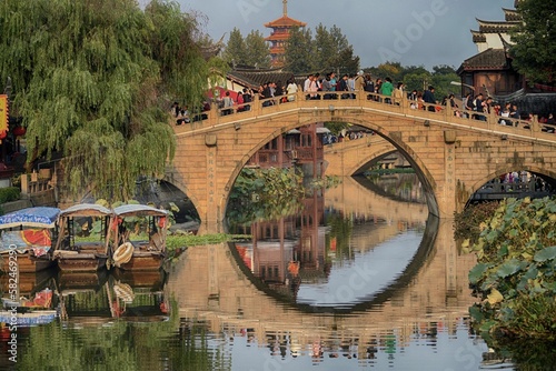 Visitors crowd across a traditional bridge in a Chinese ancient watertown near Shanghai. photo